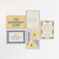 Set of five prints in butter yellow and blue: "The Homebody Club," a floral illustration, "everything is figureoutable," "The good times are here" with stars, and "you are my sunshine" with a sun