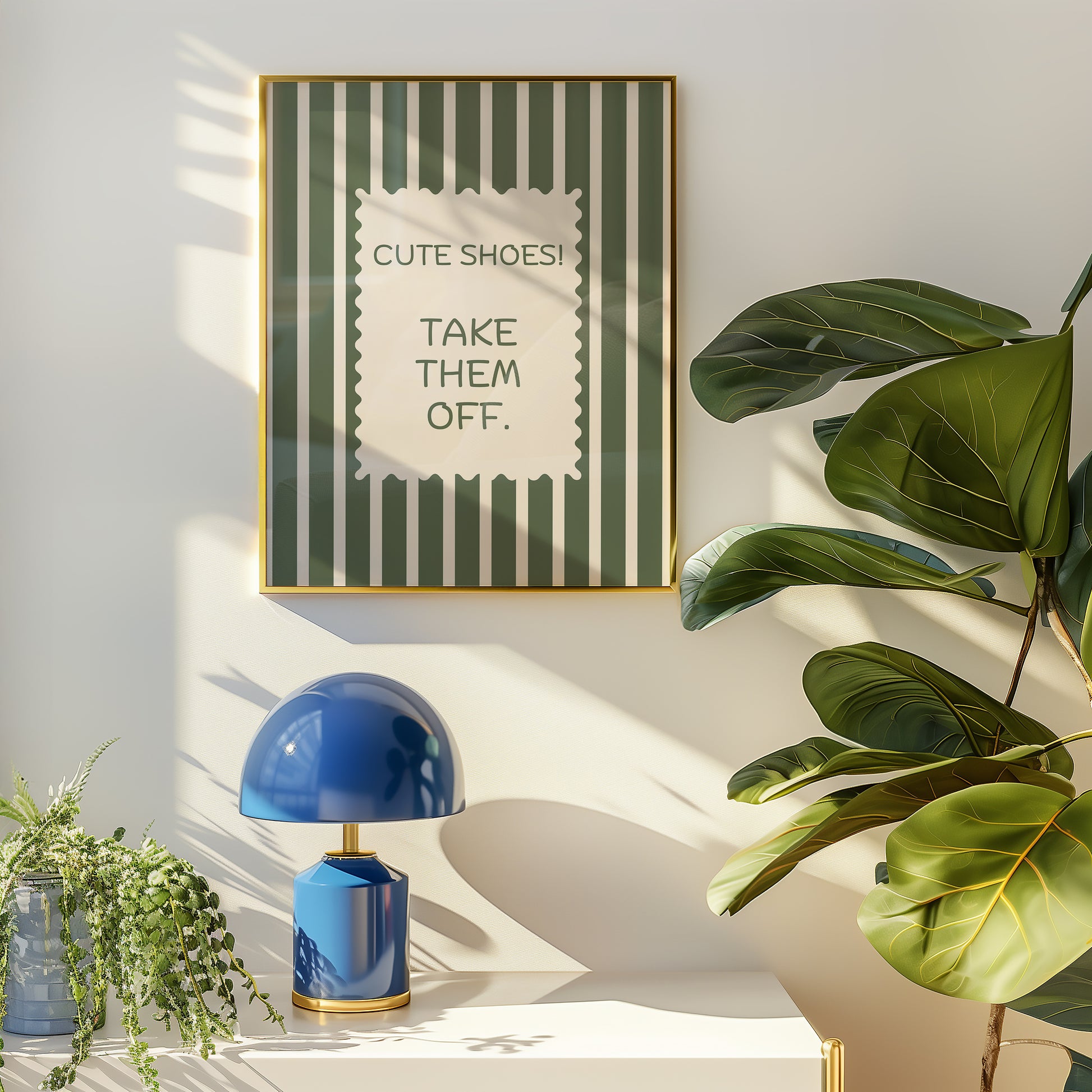 Vertical wall print with bold olive green and cream vertical stripes and a cream scalloped border text box reading Cute Shoes! Take Them Off. in matching green serif typography