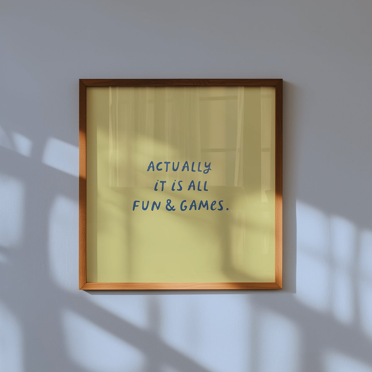 Square print with an olive green background and the quote "Actually it is all fun & games." in bold blue hand-lettered type.