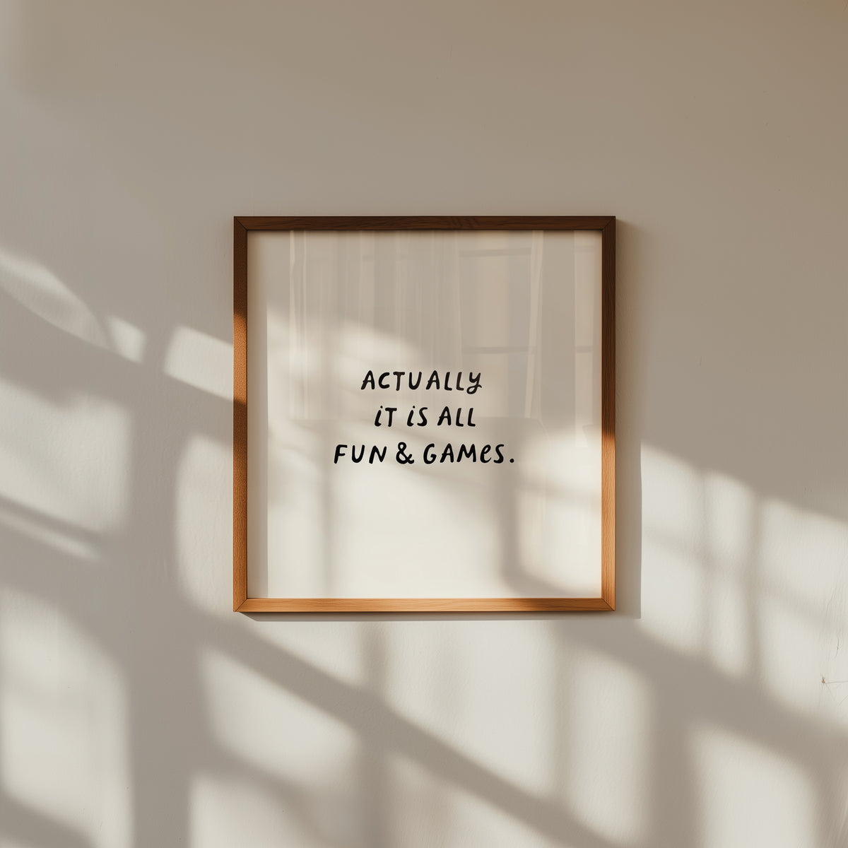 Square print with a cream background and the quote "Actually it is all fun & games." in bold black hand-lettered type.