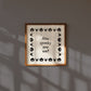 Square digital print with a cream background bordered by alternating black pumpkin and spider illustrations, framing the hand-lettered phrase "How spooky are we?" in black script.