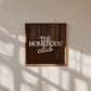 Dark brown print with "The Homebody Club" in bold cream serif and script typography