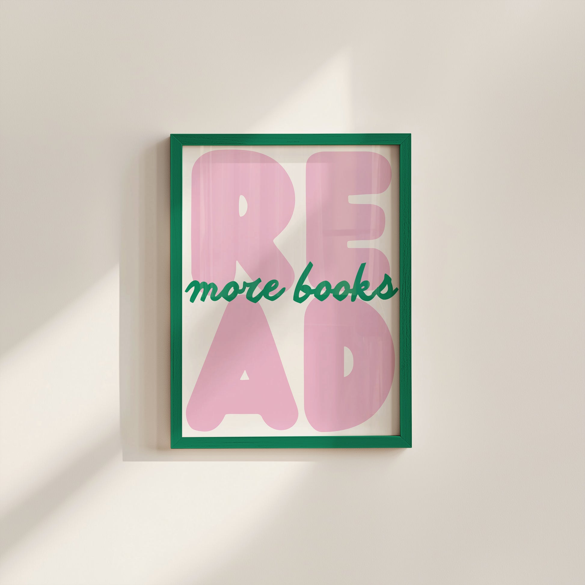 Vertical print with the word "READ" in oversized pink bubble letters and "more books" in green cursive script layered across it, on a white background.