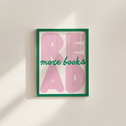 Vertical print with the word "READ" in oversized pink bubble letters and "more books" in green cursive script layered across it, on a white background.
