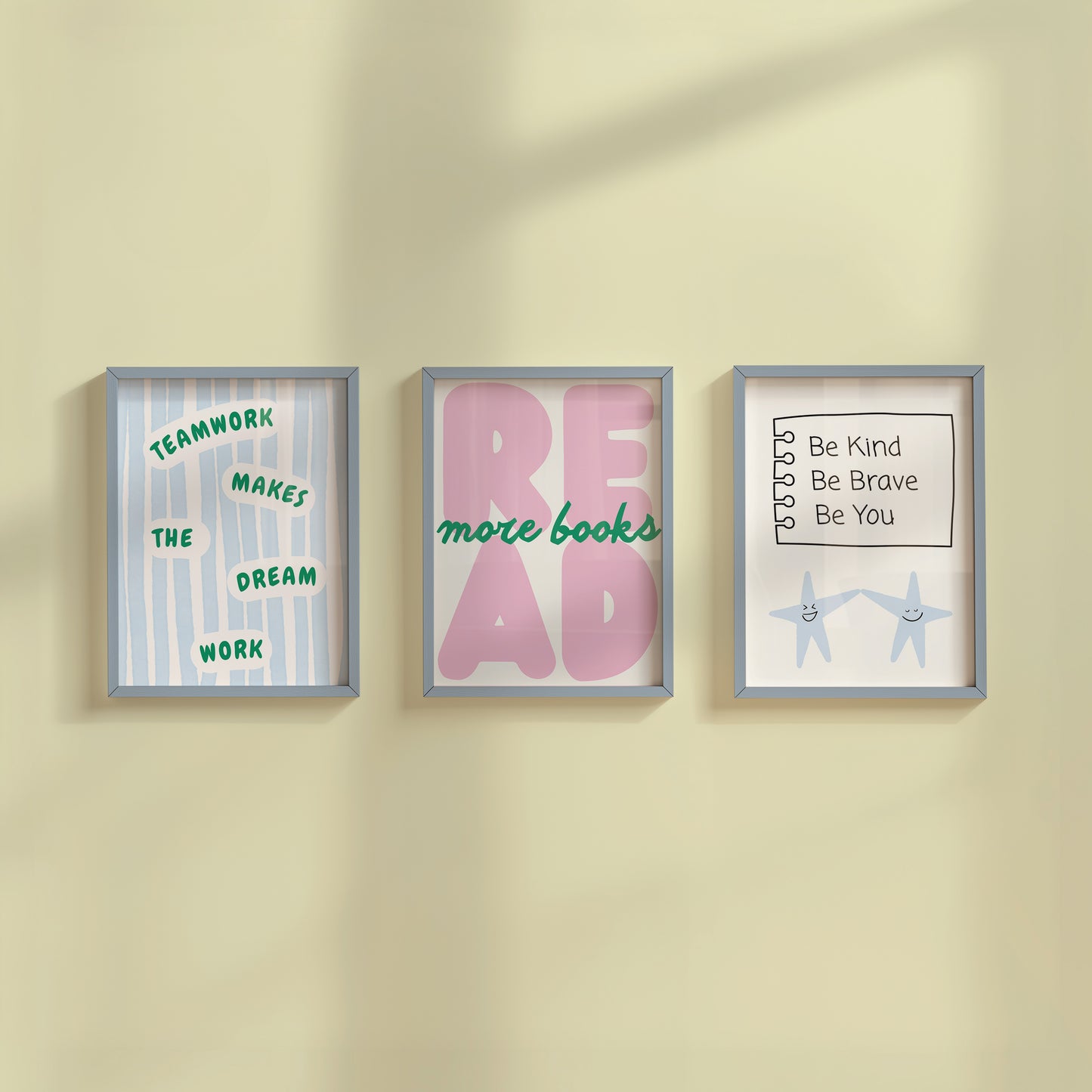 Set of 3 pastel classroom prints: "Teamwork makes the dream work" in green lettering on blue stripes, "READ more books" in pink bubble letters with green script, and "Be Kind Be Brave Be You" on a hand-drawn notebook page above two smiling star characters holding hands.
