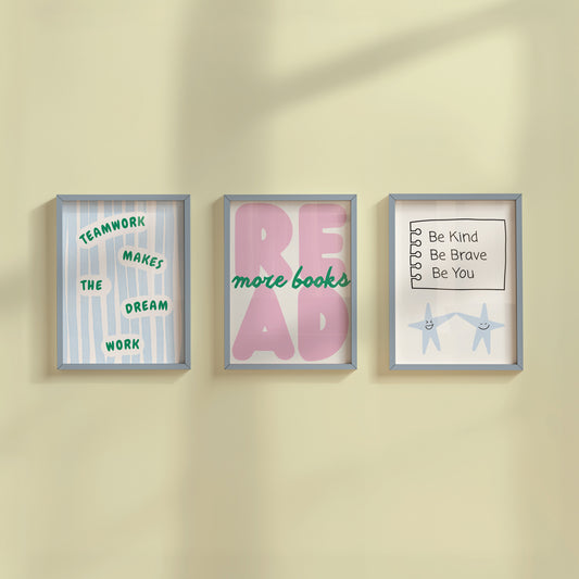 Set of 3 pastel classroom prints: "Teamwork makes the dream work" in green lettering on blue stripes, "READ more books" in pink bubble letters with green script, and "Be Kind Be Brave Be You" on a hand-drawn notebook page above two smiling star characters holding hands.