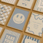 Set of 10 calm corner prints in tan and blue: "Take Your Time," "I am enough" on a smiley face, "Breathe" beside a meditating duck illustration, a "Daily Check-in, All Feelings Welcome!" chart with cartoon stars and clouds, "Slow Down, You're Doing Fine!", "You are enough," "Be Kind To Your Mind" on a checkered background, "This is a Safe Space" on a house shape, "The way you speak to yourself matters" beside a heart illustration, and "It's OK to Not Be OK."
