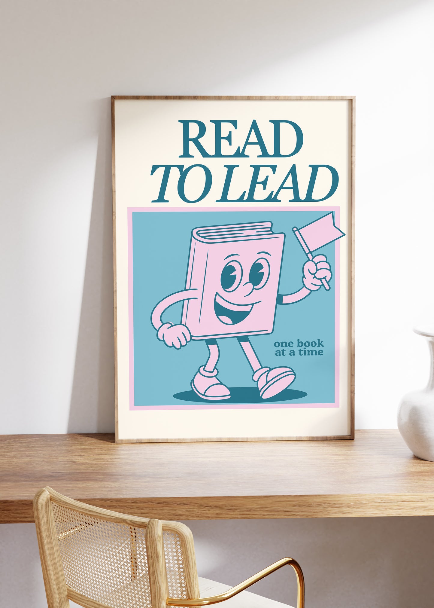 Vertical wall print with bold teal serif typography reading READ TO LEAD above a cheerful retro pink walking book character waving a flag on a teal background