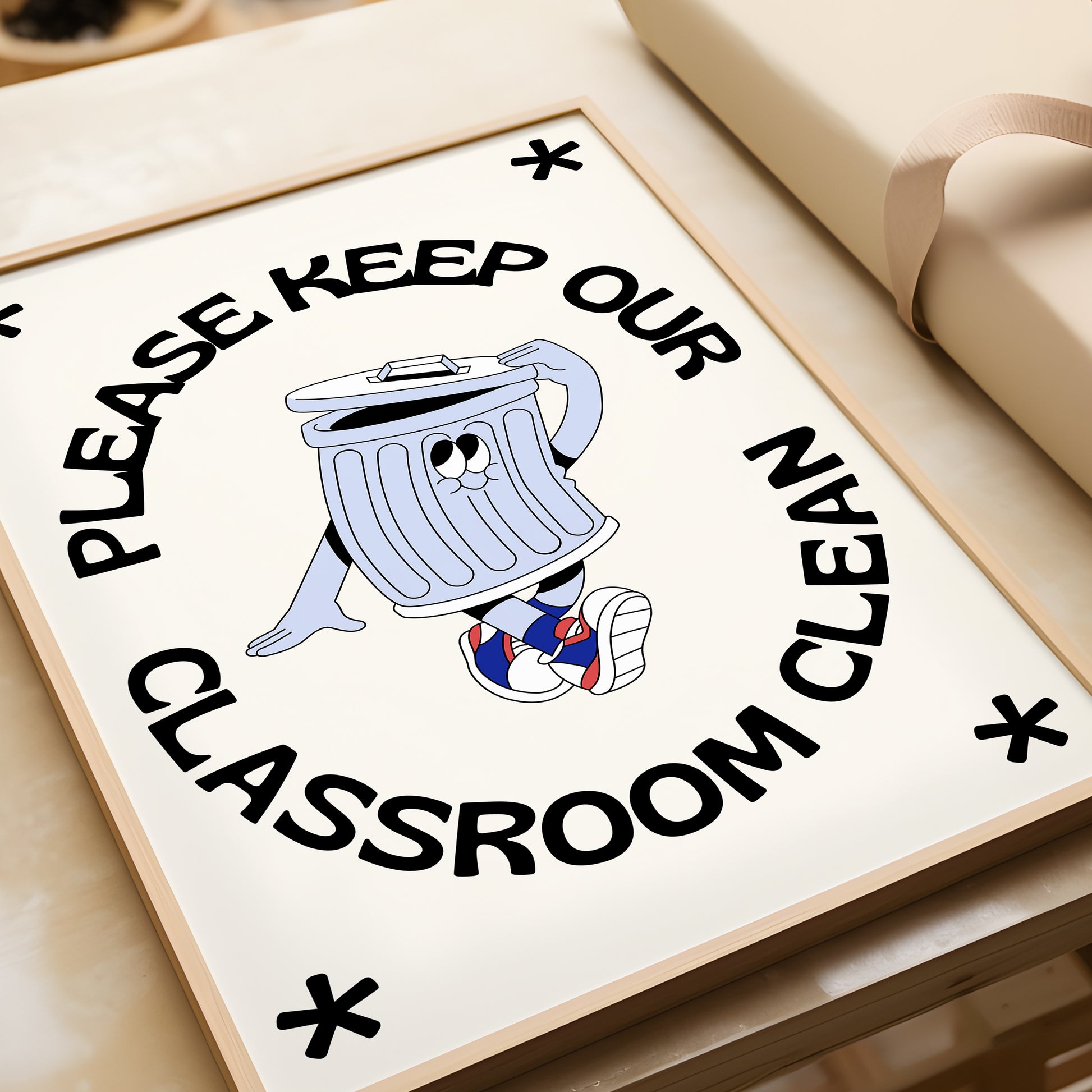Vertical cream wall print with bold arched black typography reading Please Keep Our Classroom Clean surrounding a retro cartoon trash can character wearing sneakers with asterisk corner details