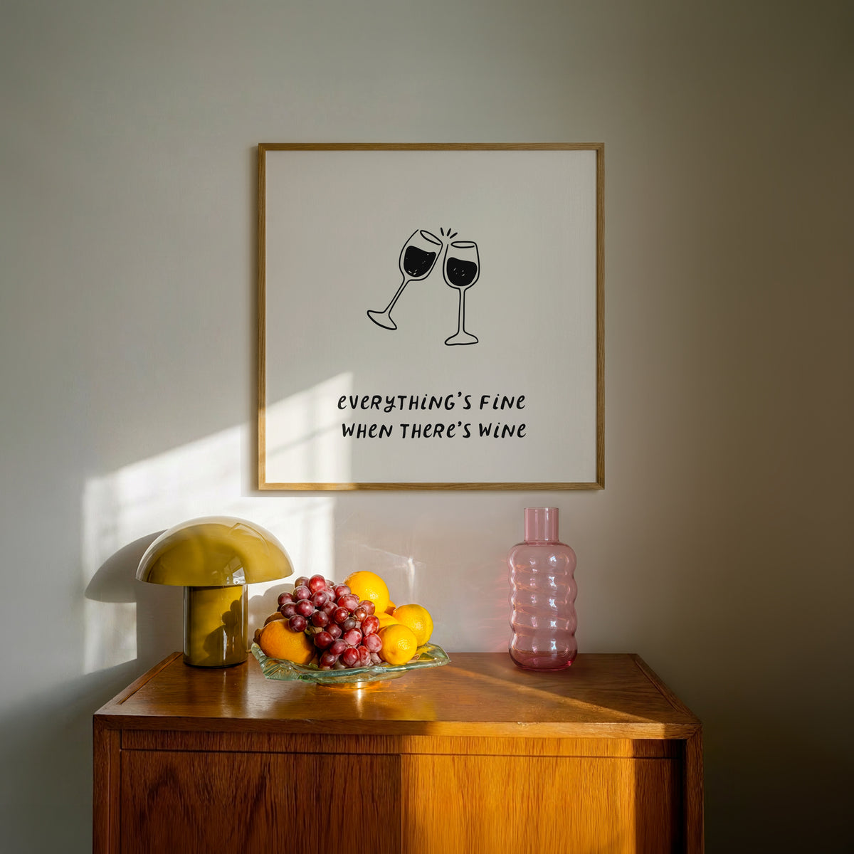 Square print with a hand-drawn illustration of two wine glasses clinking together, and the quote "everything's fine when there's wine" in bold black lettering below.