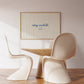 Horizontal print with thin hand-painted tan and cream vertical stripes, the quote "stay awhile" in navy cursive script, and a small hand-drawn smiley face beneath it.