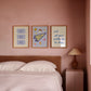 Set of 3 vertical preppy blue dorm room prints featuring a cursive stripe quote, a varsity pennant with stickers, and a retro good times ticket design