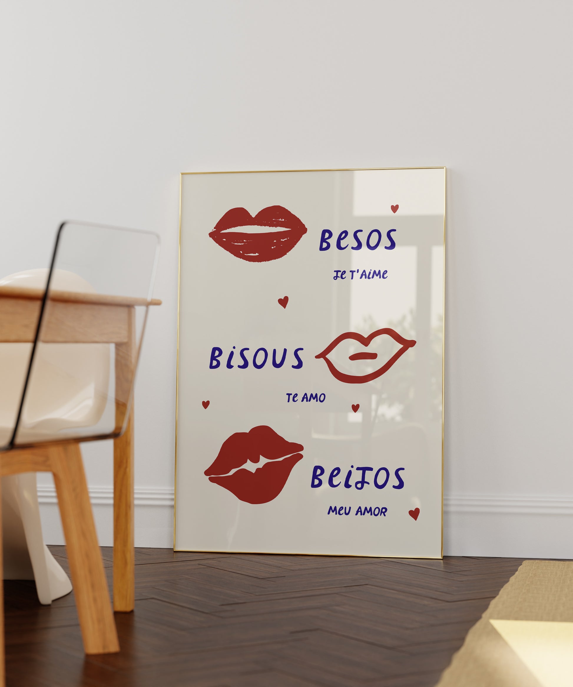 Cream print with three illustrated red lips paired with "Besos," "Bisous," and "Beijos" in navy lettering, with small red hearts scattered throughout