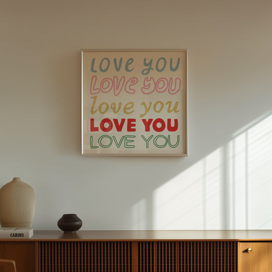 Square print with the words "Love You" repeated five times in different colors, fonts, and styles — blue, pink, gold, red, and green — stacked on a cream background.