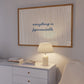 Horizontal print with thin hand-drawn sage green vertical stripes on a white background and the quote "everything is figureoutable." in navy blue cursive script at the centre.