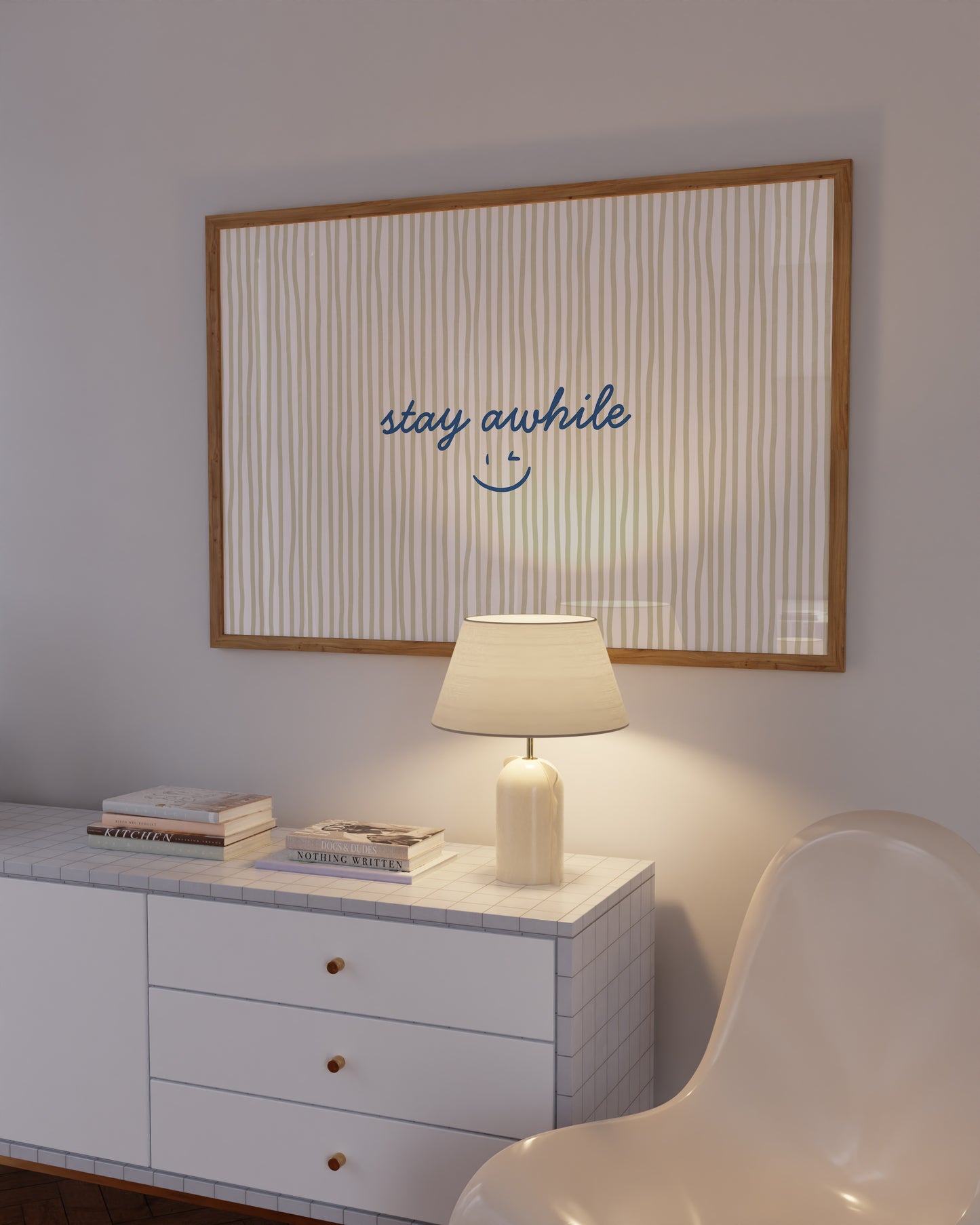 Horizontal print with thin hand-painted tan and cream vertical stripes, the quote "stay awhile" in navy cursive script, and a small hand-drawn smiley face beneath it.