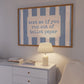 Horizontal wall print with dusty blue vertical brush stripes and a cream rounded text box in retro typewriter font reading text me if you run out of toilet paper