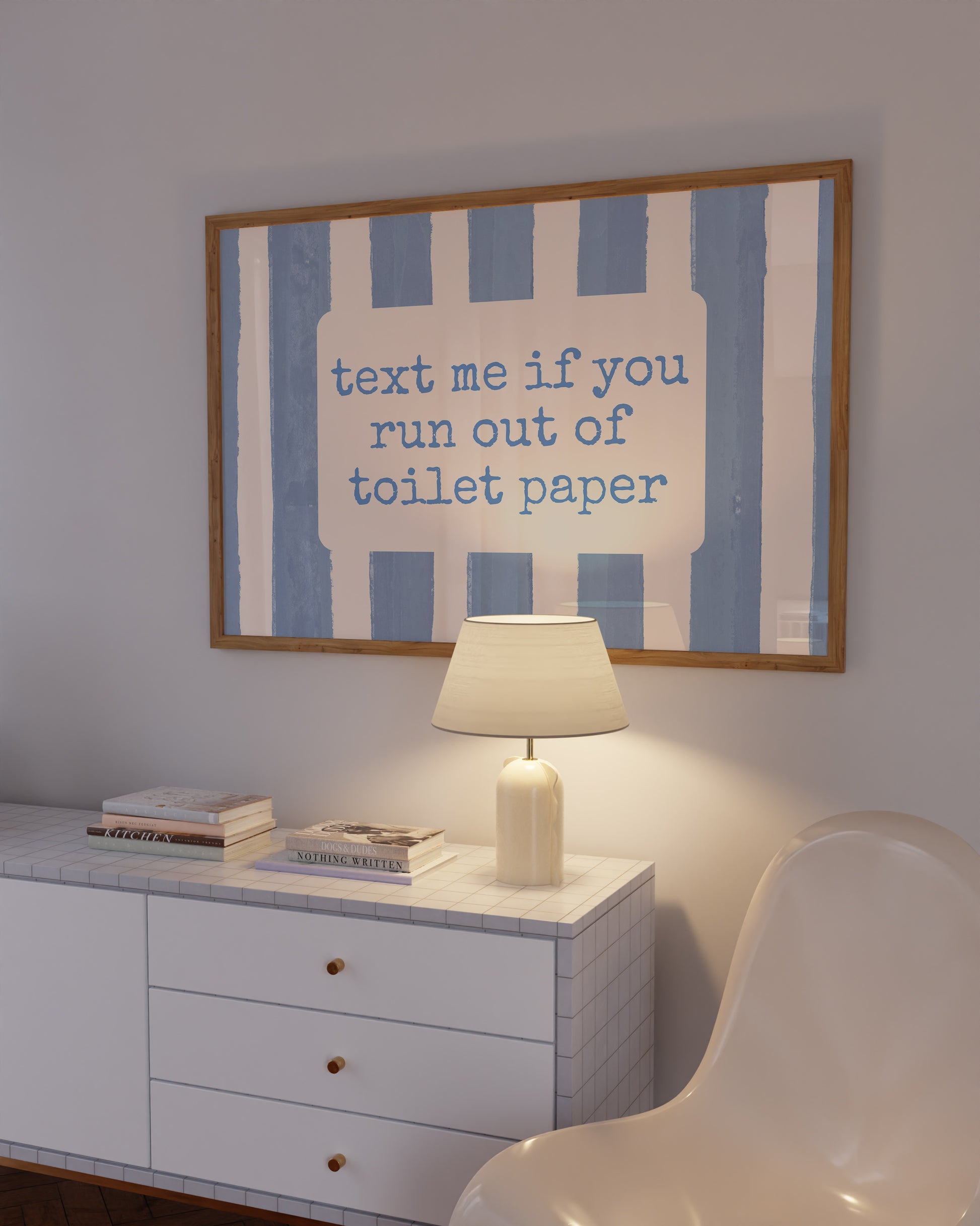 Horizontal wall print with dusty blue vertical brush stripes and a cream rounded text box in retro typewriter font reading text me if you run out of toilet paper