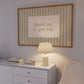 Horizontal wall print with soft sage green vertical stripes and a cream scalloped border text box reading spark joy or get out in matching sage green cursive font