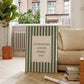 Vertical wall print with bold forest green vertical stripes and a cream scalloped text box reading Everything Always Works Out in dark green serif typography