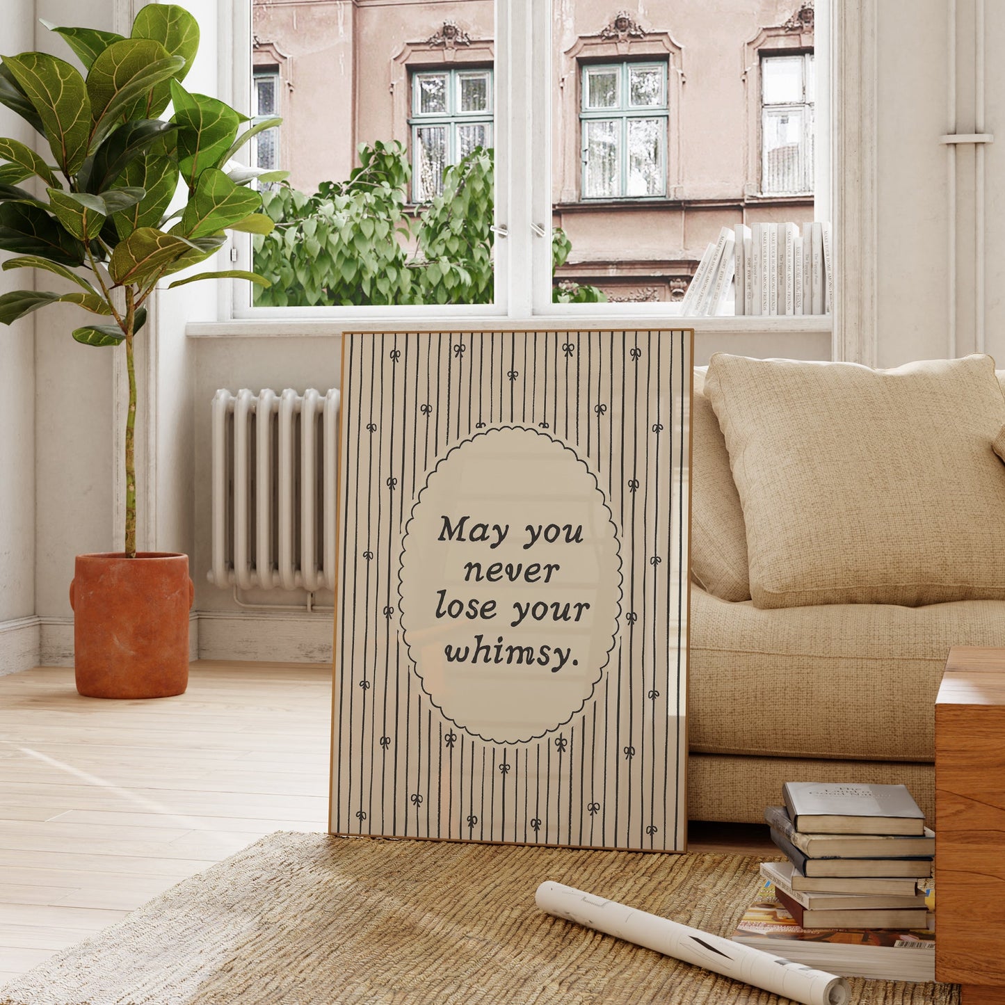 Vertical print with the quote "May you never lose your whimsy." in italic serif type inside a scalloped oval frame, surrounded by thin navy pinstripes decorated with small hand-drawn bows on a cream background.