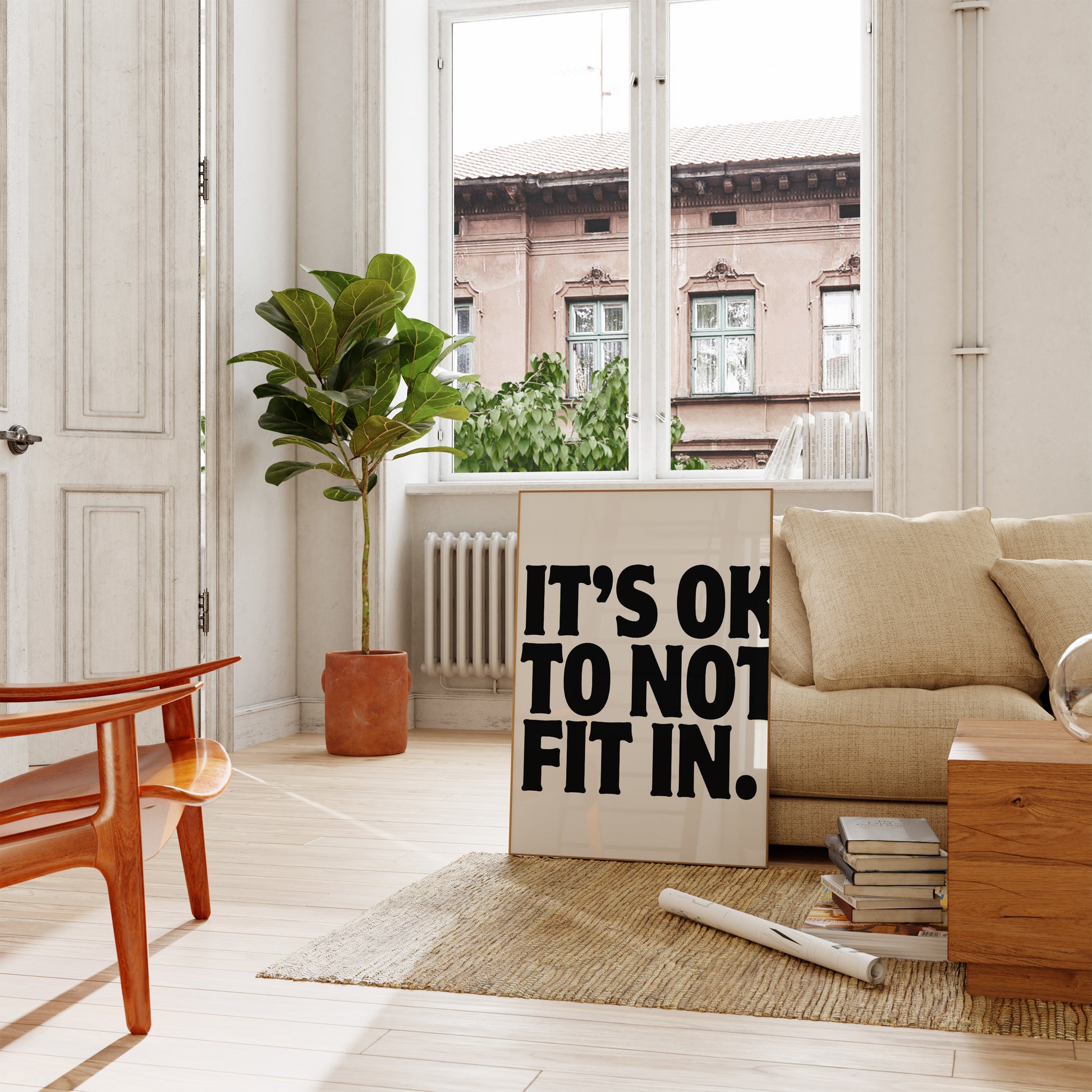 Square cream wall print with bold oversized black chunky typography reading It's Ok To Not Fit In on a clean white background