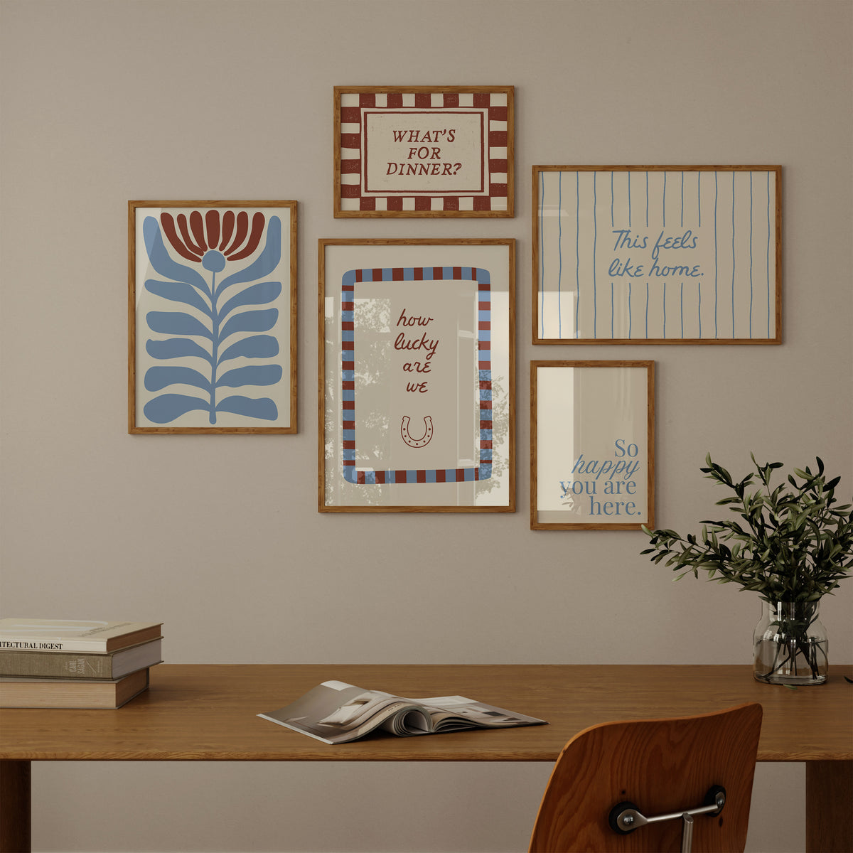 Set of five prints in rust and dusty blue: "How lucky are we" with a horseshoe, "So happy you are here," "What's for dinner?" in a checkered border, "This feels like home" on stripes, and a floral illustration