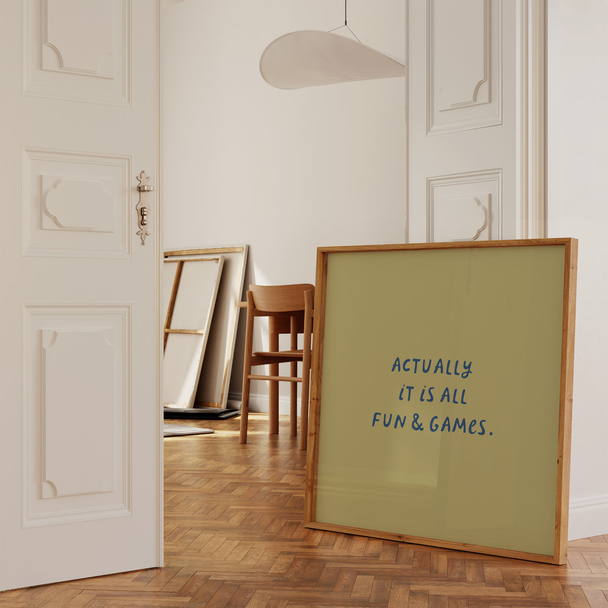 Square print with an olive green background and the quote "Actually it is all fun & games." in bold blue hand-lettered type.