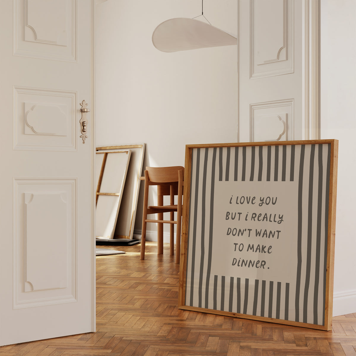 Square print with bold black and white vertical stripes framing the quote "i love you but i really don't want to make dinner" in dark gray block lettering.