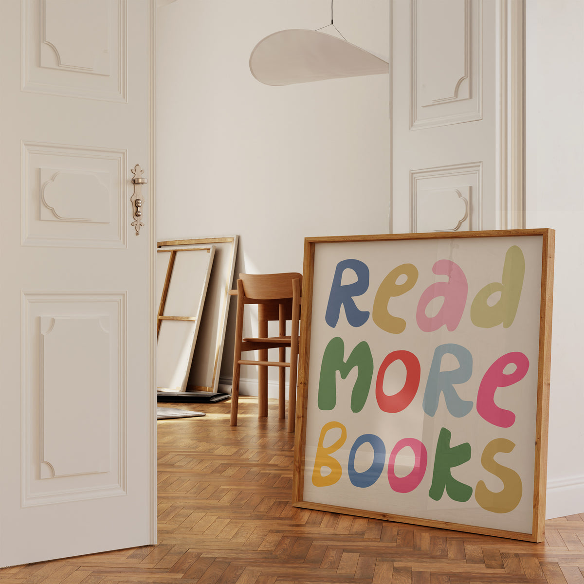 Square print with the words "Read More Books" in large multicolored bubble letters — blue, yellow, pink, green, red, and orange — stacked on three lines against a cream background.