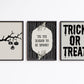 Set of 3 black and white Halloween prints: dripping "Trick or Treat" typography, "'Tis the season to be spooky" framed by skeleton hands, and a black silhouette branch with hanging jack-o'-lanterns.