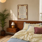 Set of five prints in butter yellow and blue: "The Homebody Club," a floral illustration, "everything is figureoutable," "The good times are here" with stars, and "you are my sunshine" with a sun