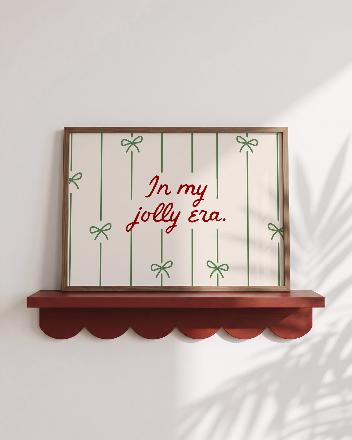 Christmas print with "In My Jolly Era" script text and green bow illustrations on cream striped background
