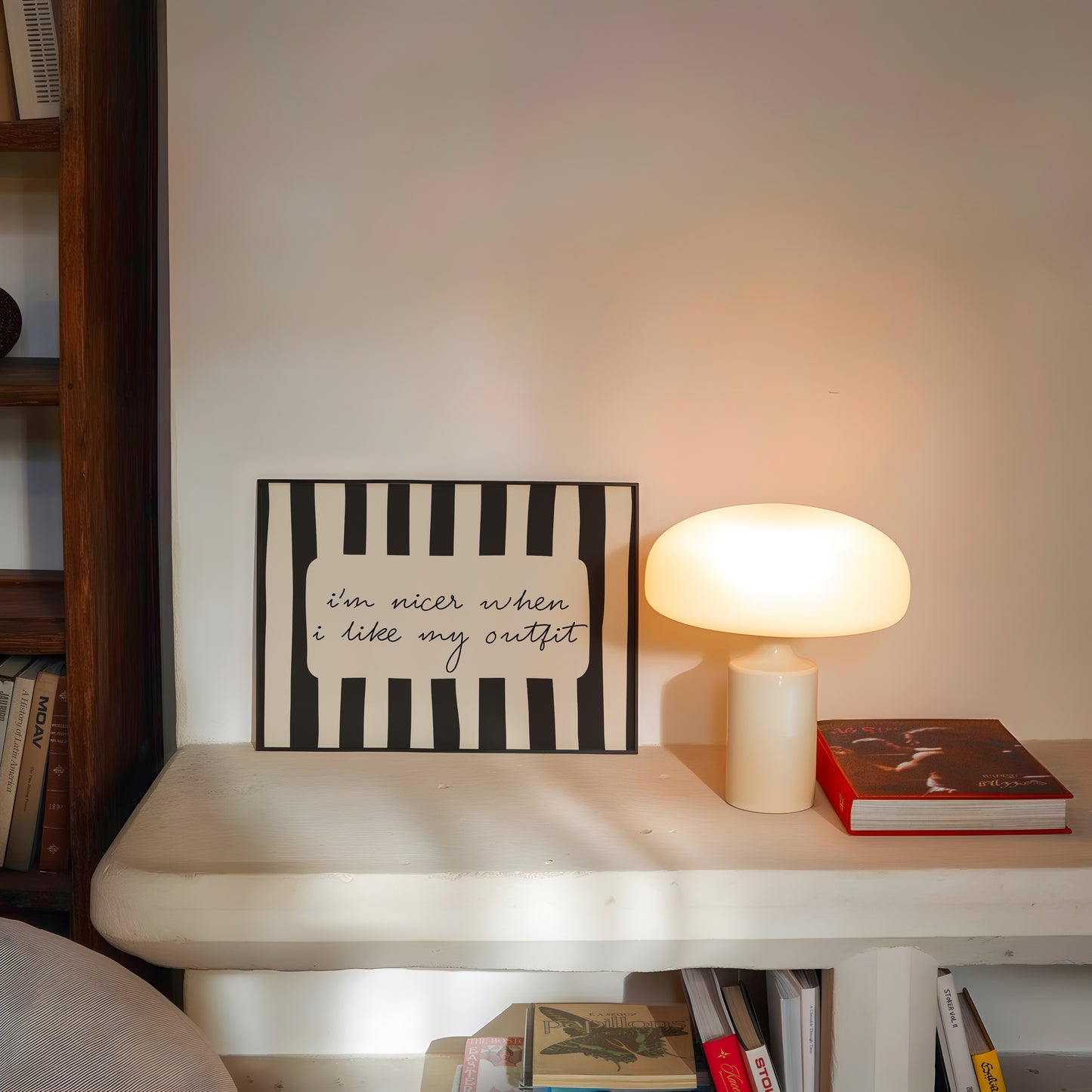 Horizontal print with bold black and white vertical stripes framing the handwritten cursive quote "i'm nicer when I like my outfit" in a rounded cream panel.