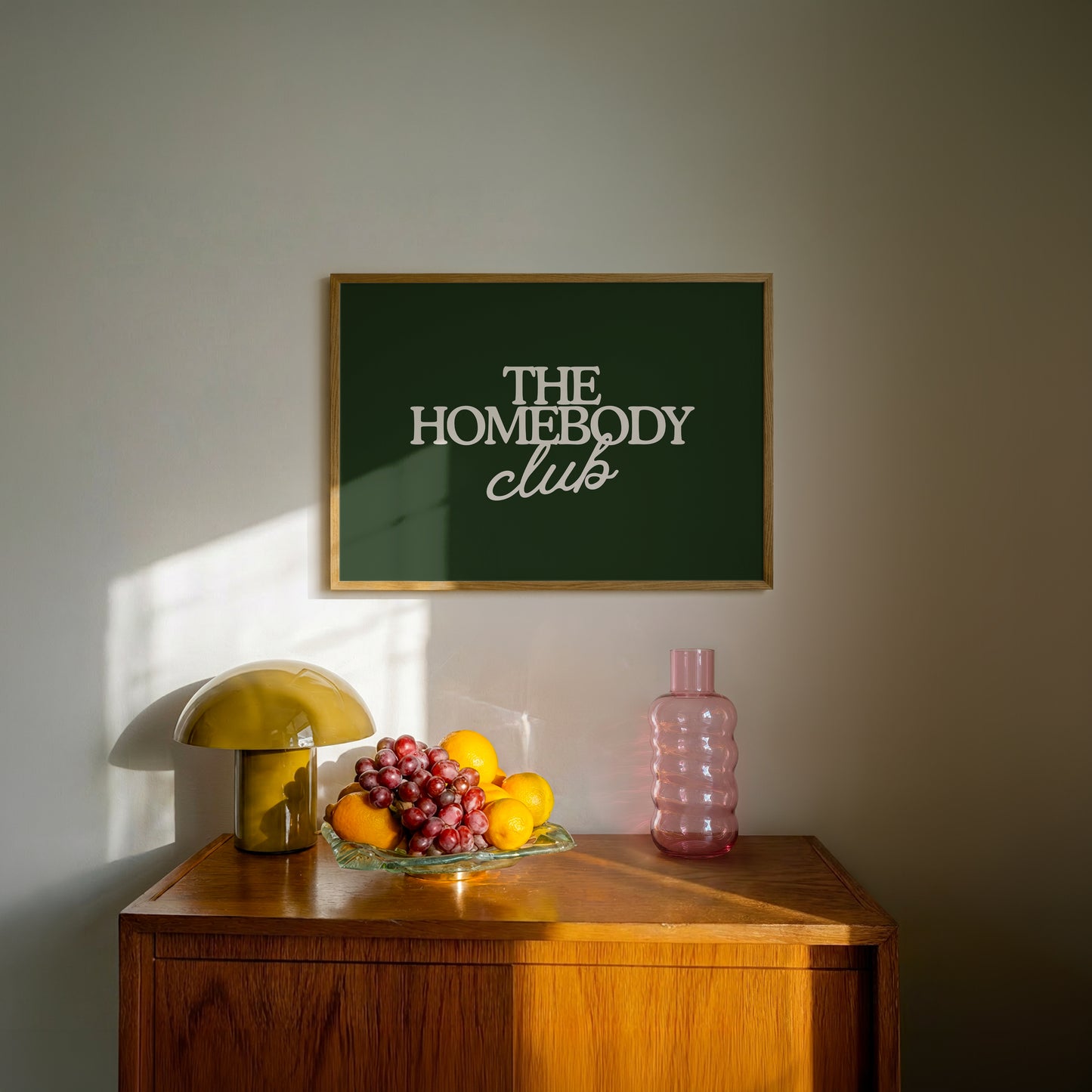 Dark green print with "The Homebody Club" in cream serif and script typography
