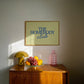 Rectangular landscape digital print with an olive-green background featuring "THE HOMEBODY" in bold blue serif type stacked above "club" in blue cursive script, centered typography layout.
