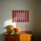 Horizontal print with bold red and pink vertical stripes and a hand-drawn ice cream cone illustration inside a rectangular border, with the words "HAVE A SWEET TREAT" in outlined block lettering.