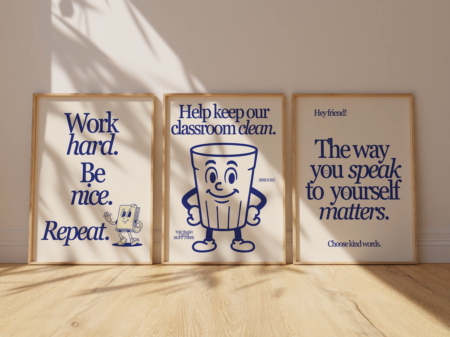 Set of 3 vertical navy and cream retro classroom prints with bold typography and character mascots including a trash can and walking book