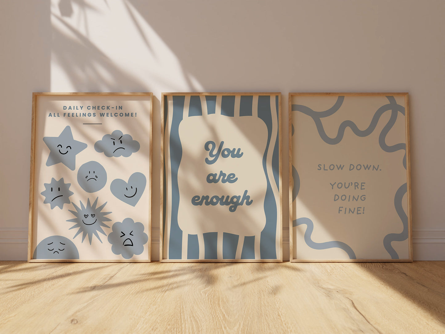 Set of 10 calm corner prints in tan and blue: "Take Your Time," "I am enough" on a smiley face, "Breathe" beside a meditating duck illustration, a "Daily Check-in, All Feelings Welcome!" chart with cartoon stars and clouds, "Slow Down, You're Doing Fine!", "You are enough," "Be Kind To Your Mind" on a checkered background, "This is a Safe Space" on a house shape, "The way you speak to yourself matters" beside a heart illustration, and "It's OK to Not Be OK."