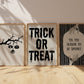 Set of 3 black and white Halloween prints: dripping "Trick or Treat" typography, "'Tis the season to be spooky" framed by skeleton hands, and a black silhouette branch with hanging jack-o'-lanterns.