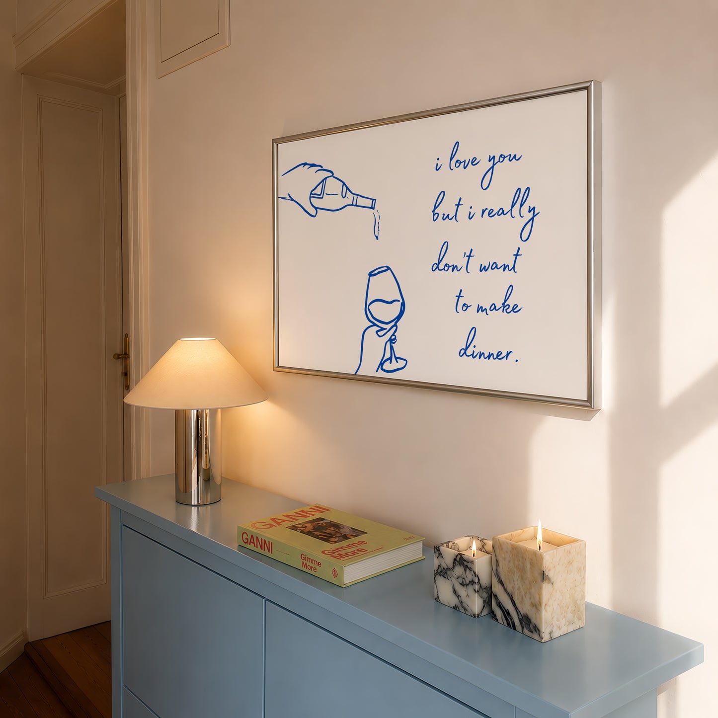 Print with hand-drawn blue line art of a bottle pouring wine into a glass beside the cursive quote "i love you but i really don't want to make dinner."