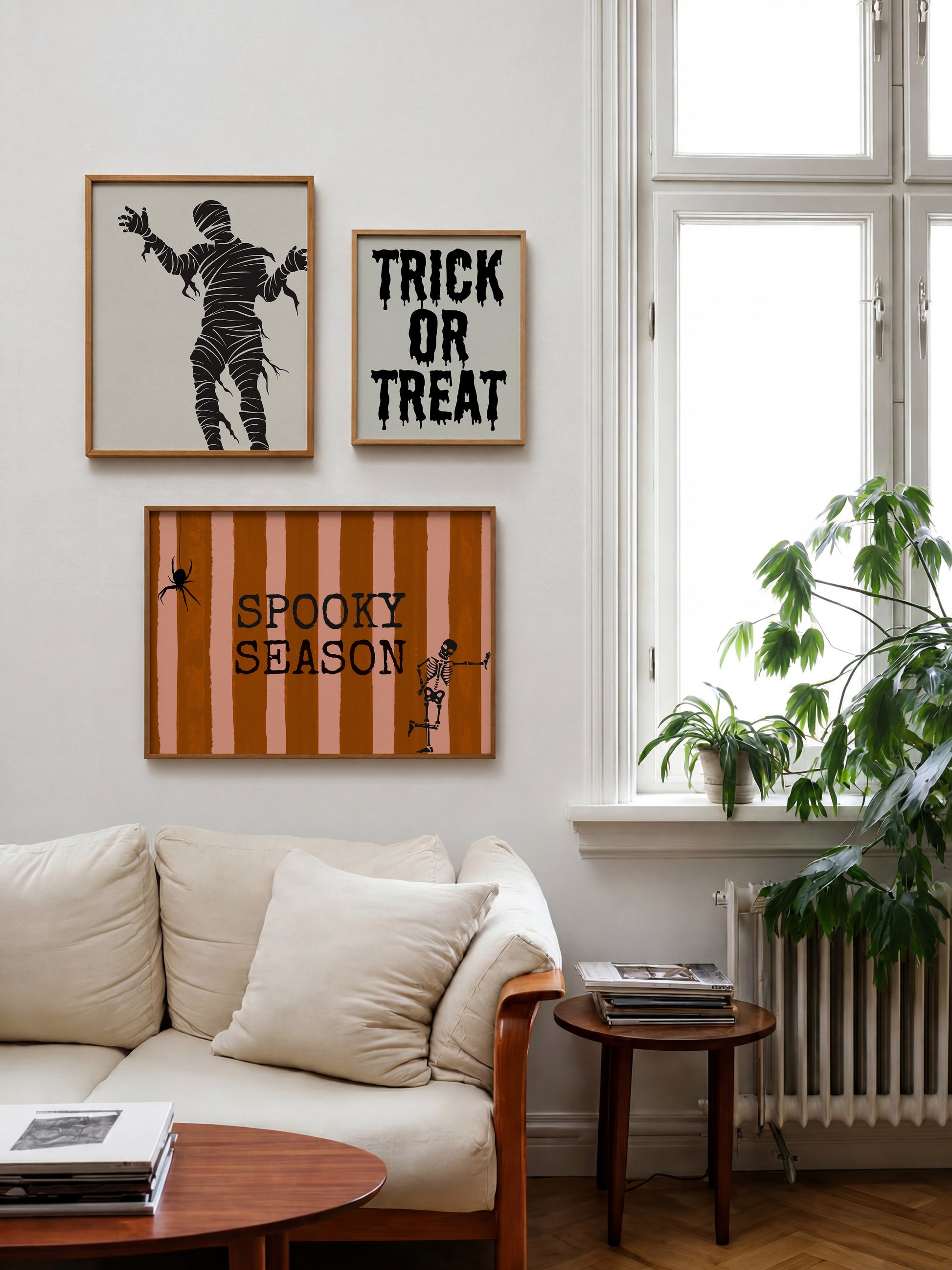 Set of 3 Halloween prints: "Trick or Treat" in dripping black lettering, "Spooky Season" on orange striped fabric with a spider and skeleton, and a bold black silhouette of a mummy.