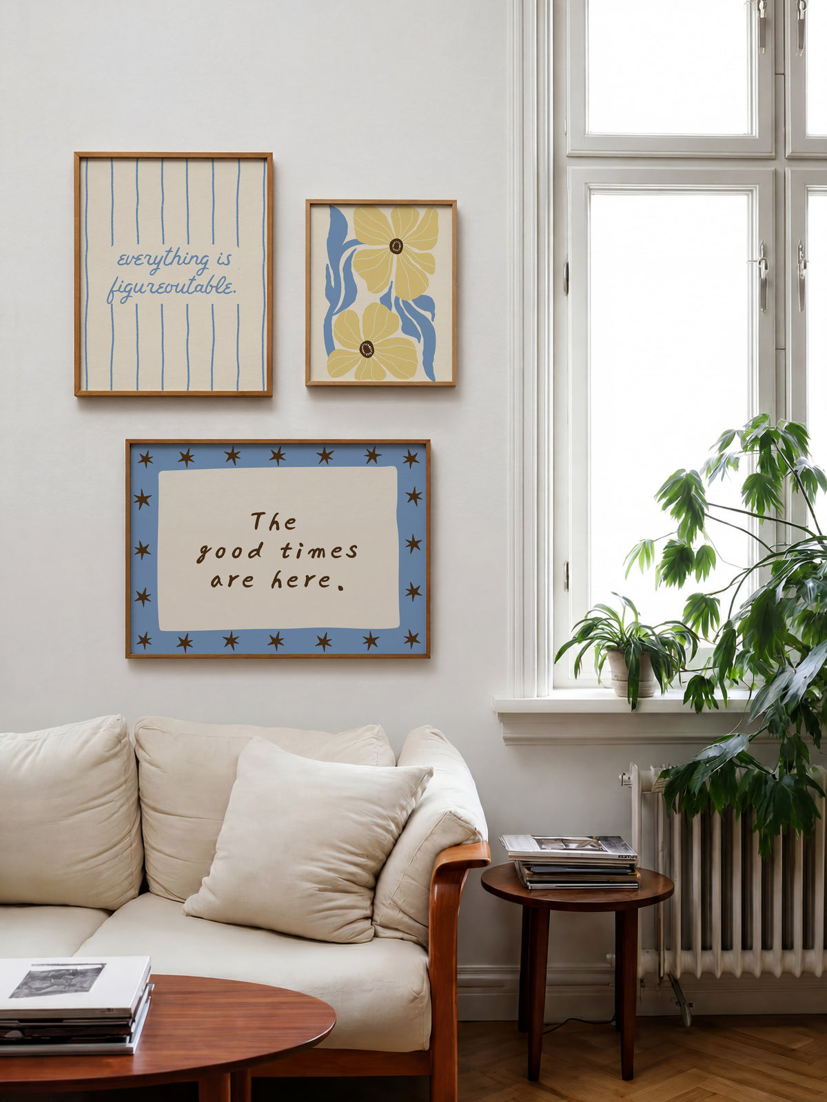 Set of five prints in butter yellow and blue: "The Homebody Club," a floral illustration, "everything is figureoutable," "The good times are here" with stars, and "you are my sunshine" with a sun