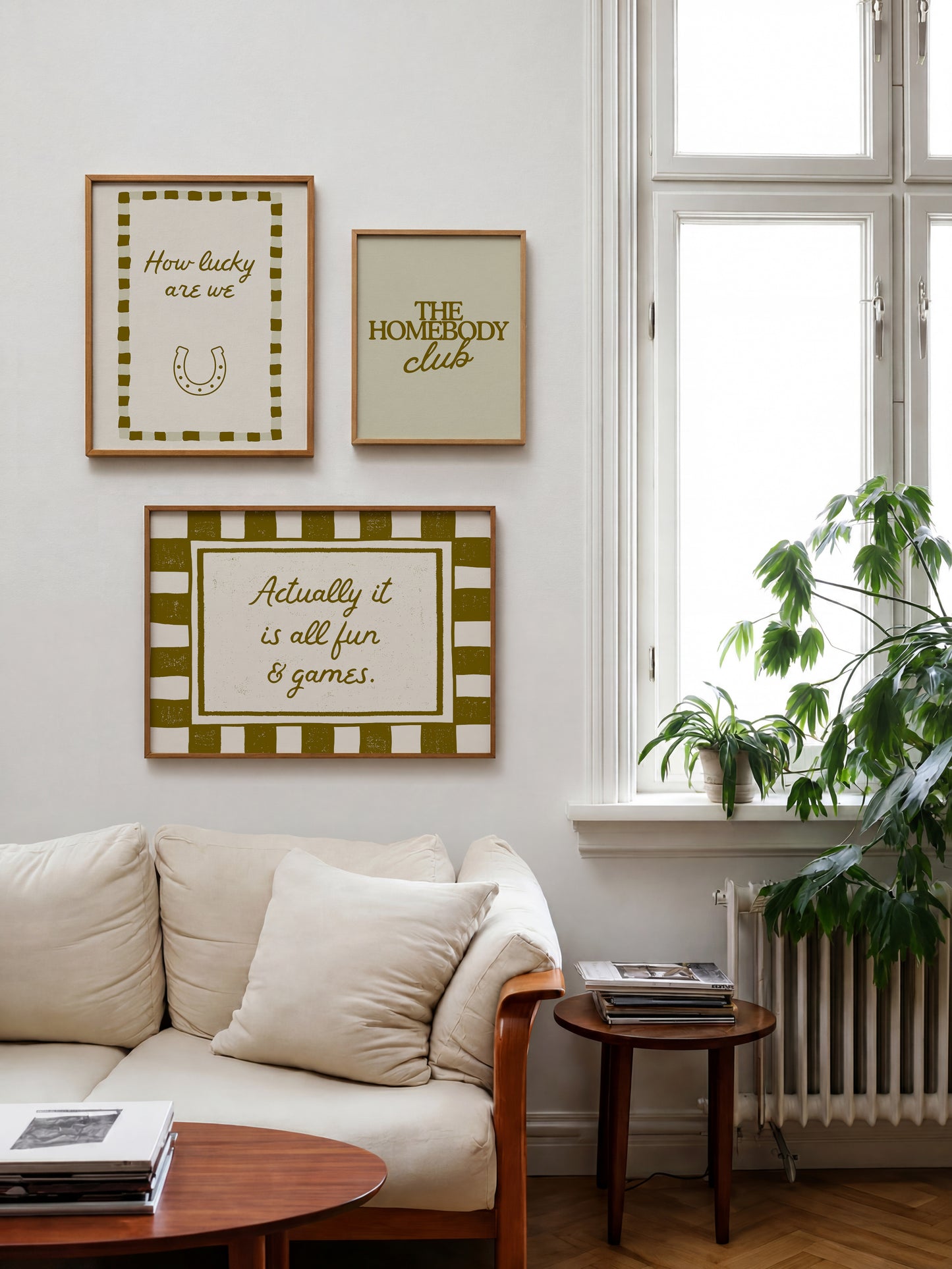Set of five olive and cream prints including a checkered 'Actually it is all fun & games' print, a horseshoe 'How lucky are we' print, 'The Homebody Club', a striped 'good old days' print, and bubble-letter 'Home sweet'