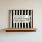 Horizontal print with bold black and white vertical stripes framing the handwritten cursive quote "i'm nicer when I like my outfit" in a rounded cream panel.