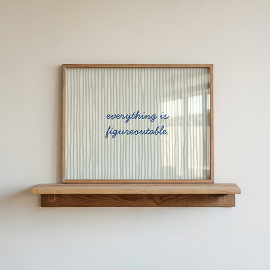 Horizontal print with thin hand-drawn sage green vertical stripes on a white background and the quote "everything is figureoutable." in navy blue cursive script at the centre.