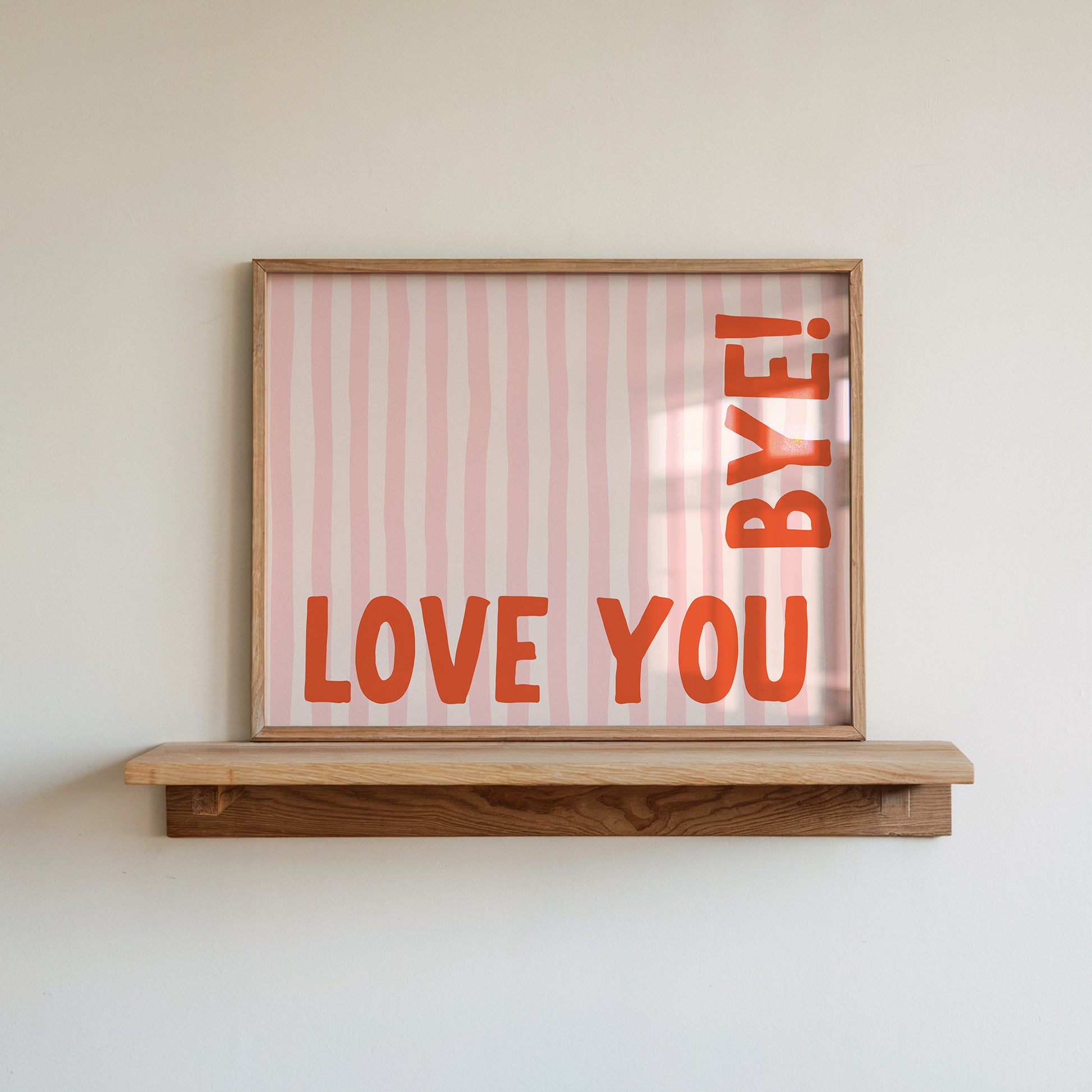 Horizontal wall print with soft pink wavy vertical stripes and bold red rounded typography reading LOVE YOU BYE! in the bottom corner