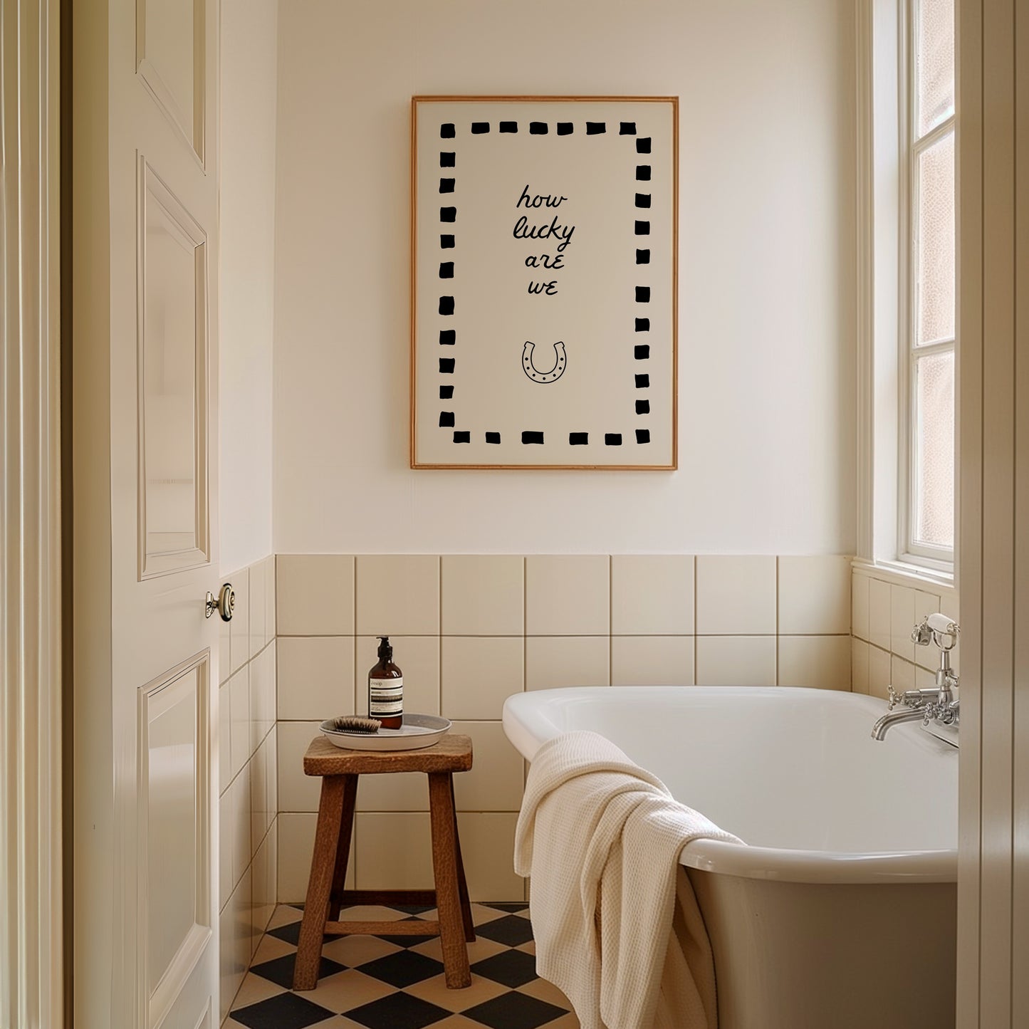 Cream print with a black dashed border featuring the handwritten quote 'how lucky are we' and a horseshoe illustration