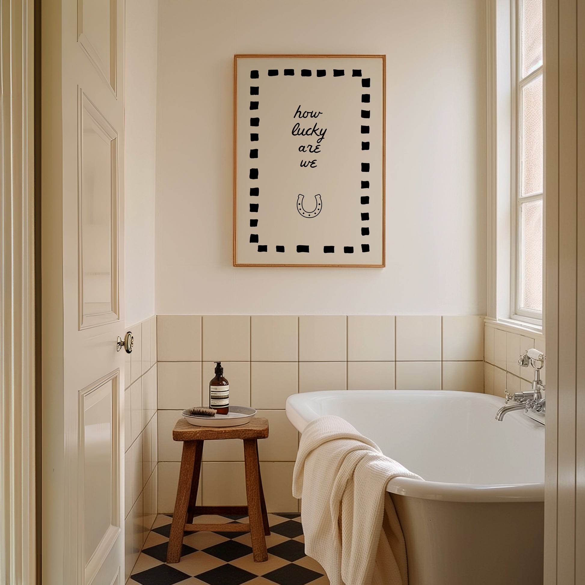 Cream print with a black dashed border featuring the handwritten quote 'how lucky are we' and a horseshoe illustration