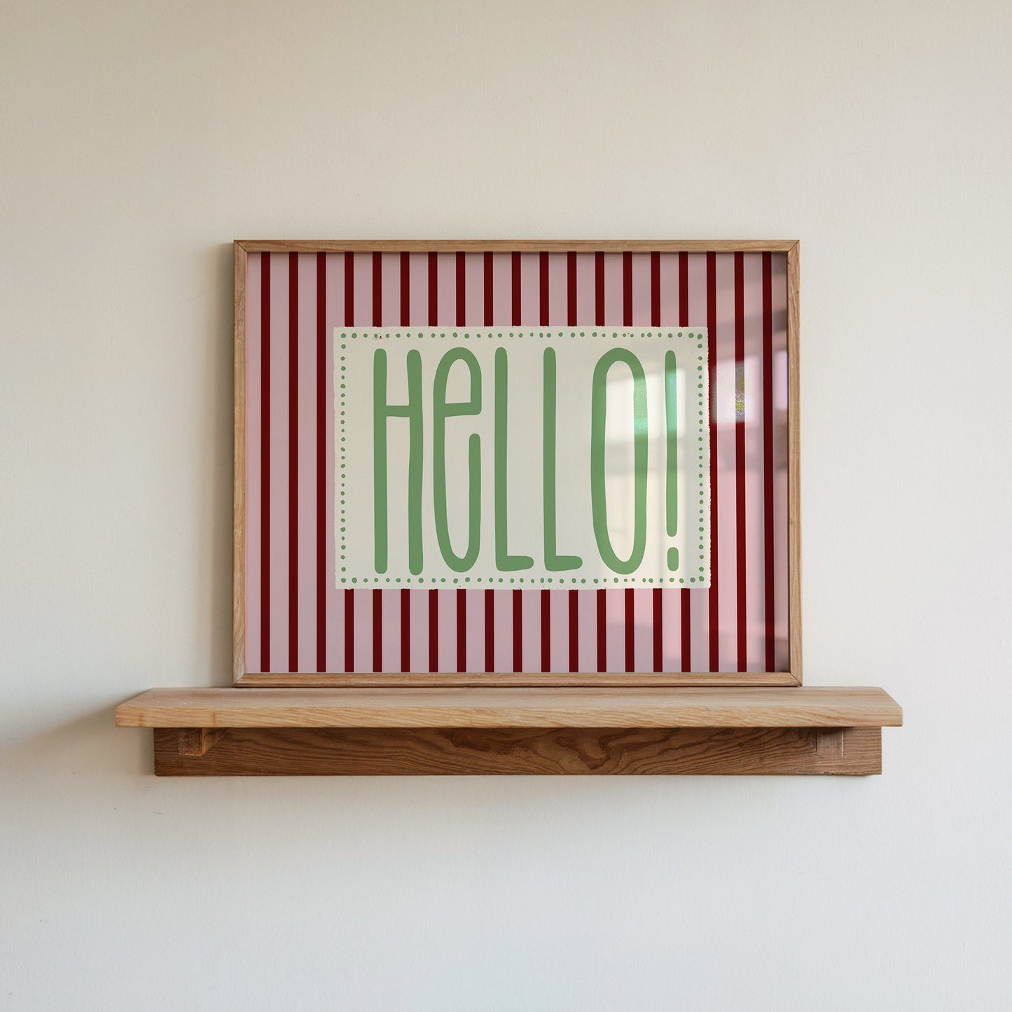 Hello retro stripe print in a wood frame on a shelf